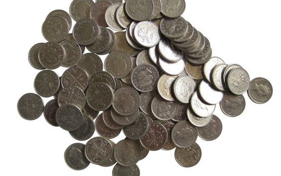 5 Pence coins on white background